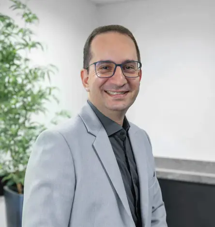 Daniel Lopes, Director and Founder of HYTRON, standing indoors and smiling at the camera.