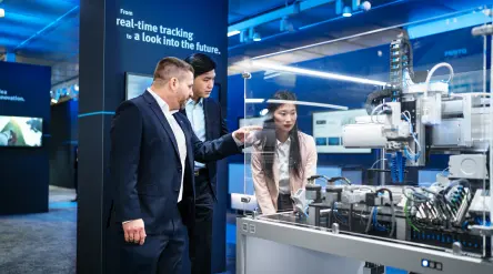 Festo customers have an interactive display explained to them at the trade fair.