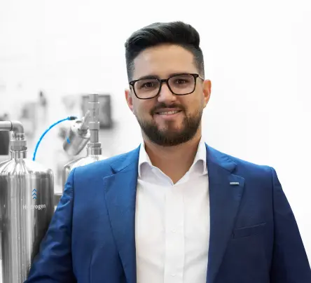 Manuel Serrano, Automation Engineer for the Process Industry at Festo South America, standing next to industrial equipment.